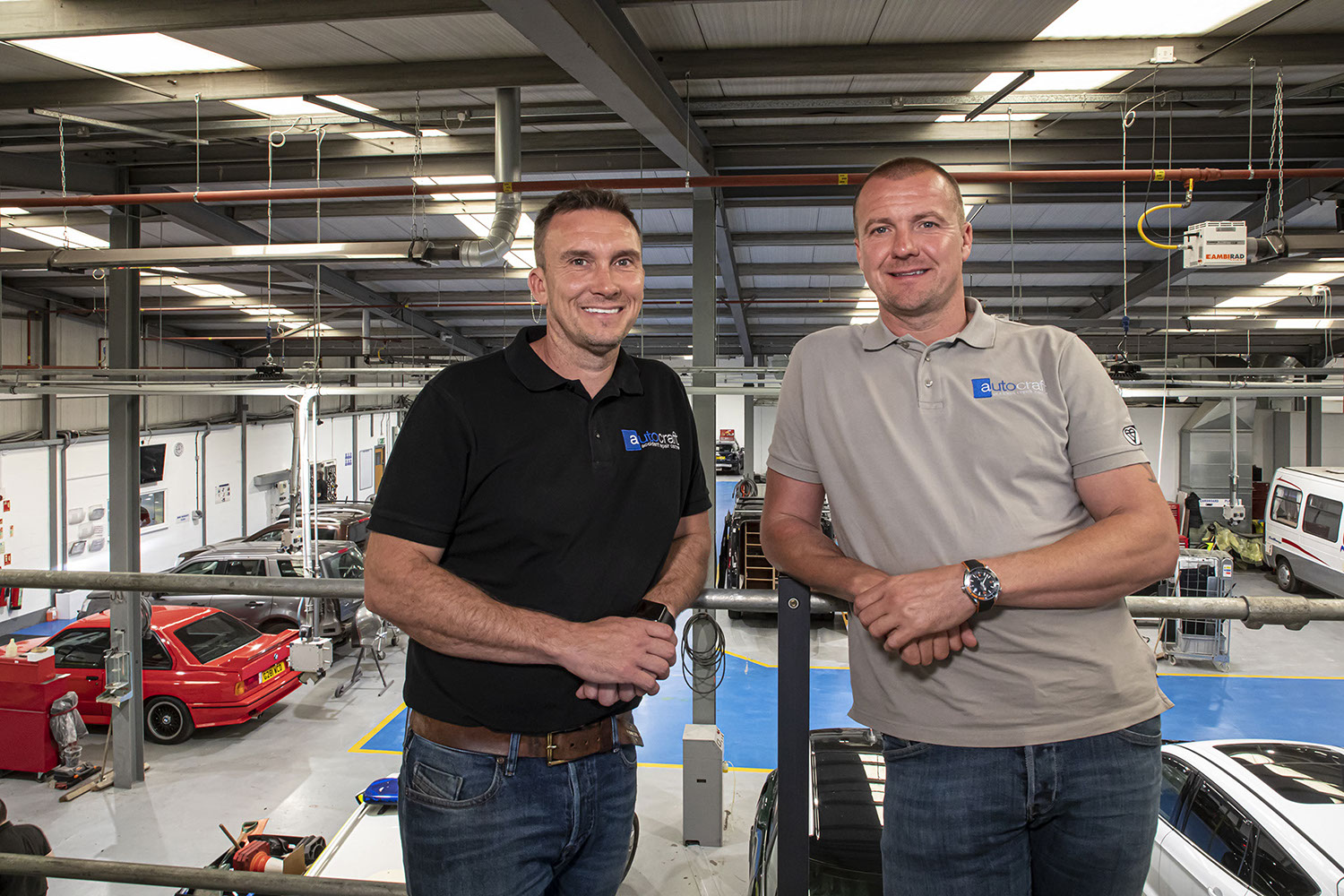Autocraft Bodyshop owners, bodyshop in background.